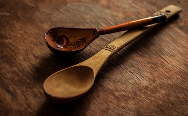 Wooden spoons on the table. Still life. The history of culture. Brown background.