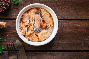 canned salmon, fish preserves seafood in tin can menu concept background. top view. copy space for text ketogenic diet, paleo or pescatarian