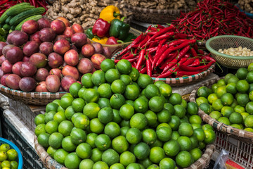 Baskets with fruits and vegetables, lime, pepper on the traditional  street market, Hanoi, Vietnam.