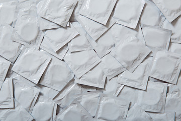 background texture of many gray condoms. Sex education