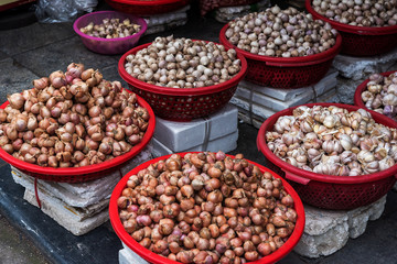 Baskets with garlic and onion on the traditional  street market, Hanoi, Vietnam.