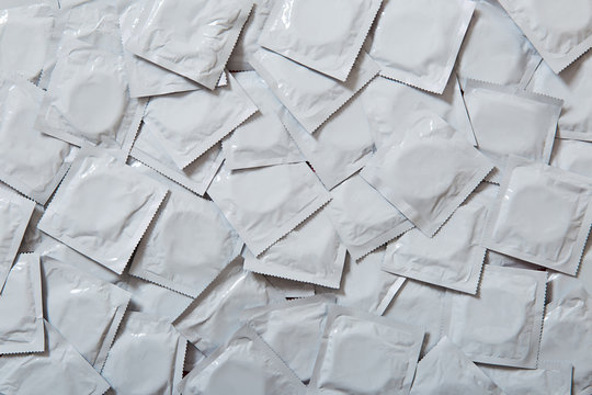 background texture of many gray condoms. Sex education