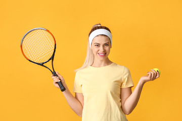 Portrait of beautiful tennis player on color background