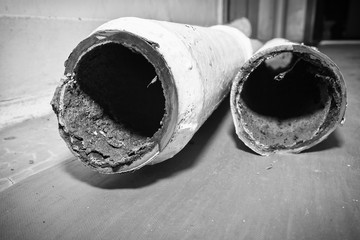 Two pieces of an old sewer pipe. Apartment in a multi-storey residential building in the city....