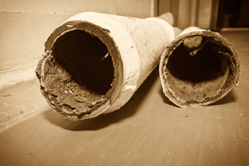 Two pieces of an old sewer pipe. Apartment in a multi-storey residential building in the city....