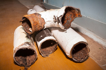 Fragments of an old pipe. Apartment in a multi-storey residential building in the city. Several...
