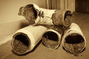Pastel image. Stylized antique. Replacing old sewer pipes in an apartment of a multi-storey...