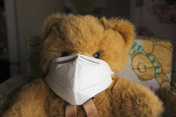 Coronavirus child: teddy bear with mask - 345417309