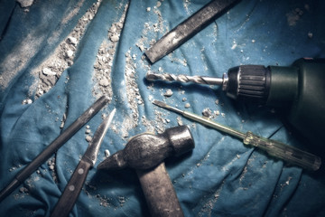 Home wizard hand tool kit for job execution. Repair of an electric line in an apartment of a multi-storey building. Color photo. Stylized antique.