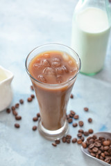 Glass of tasty iced coffee on color background