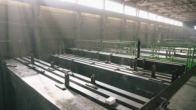 Fabricated stacks of concrete slabs in drying chamber. Production of reinforced concrete panels