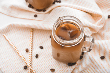 Obraz na płótnie Canvas Mason jar of tasty iced coffee on table