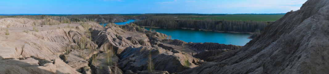 Fototapeta na wymiar Sandy quarry with blue water called Conduky or Romance Mountains panorama