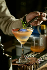 cocktail with kumquat on wooden background