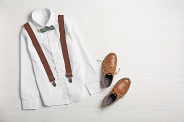 Stylish school uniform on white wooden background