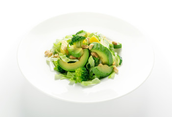 Green Salad with Avocado, Cucumber and Nuts on White Plate