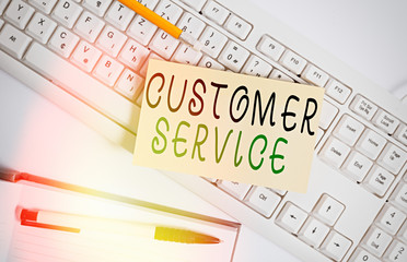 Handwriting text writing Customer Service. Conceptual photo process of ensuring client satisfaction with product White keyboard with note paper and clips on white background