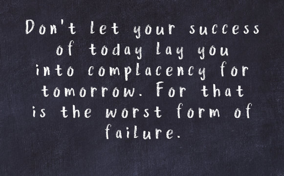 Chalk inscription of smart quote on black desk