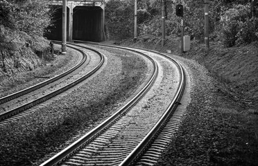 Railroad, two tracks. The frame is a smooth rotation. Entry into the tunnel. Black and white photo,...