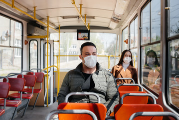 Naklejka premium Passengers on public transport during the coronavirus pandemic keep their distance from each other. Protection and prevention covid 19