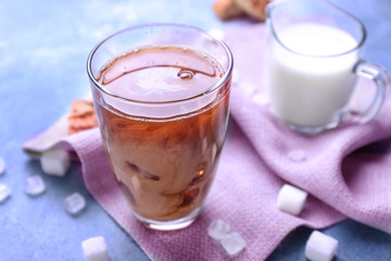 Glass of tasty iced coffee on color background