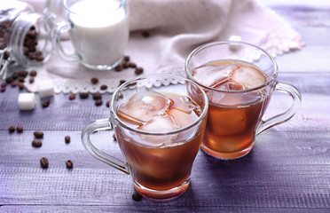 Cups of tasty iced coffee on table