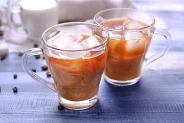 Cups of tasty iced coffee on table