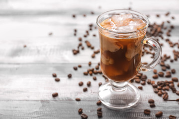 Cup of tasty iced coffee on table