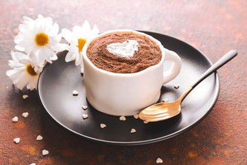 Chocolate cake in shape of coffee cup on plate