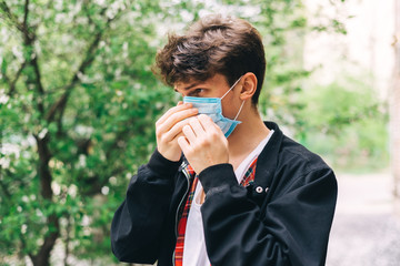 Portrait of a young guy with a mask on his face. Coronavirus2020. Health concept, stay at home, go outside put on a mask.