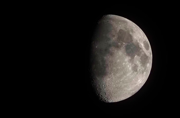 First quarter of the moon is seeing on the night sky