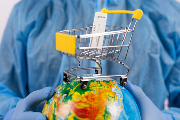 Hands in medical gloves holding a globe with coronavirus test, online shopping during a pandemic