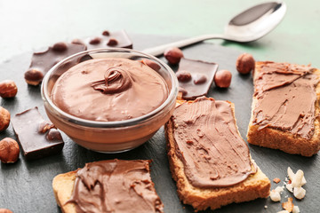 Fresh bread and chocolate paste on slate plate, closeup