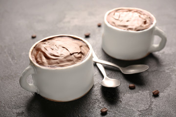 Chocolate cakes in shape of coffee cups on grunge background