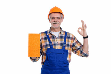 Repair service and renovation concept. Senior handyman home repair, male in helmet laborer on white background, okay signal and nice work