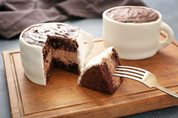 Chocolate cakes in shape of coffee cups on board