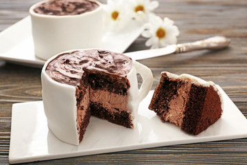 Chocolate cake in shape of coffee cup on table