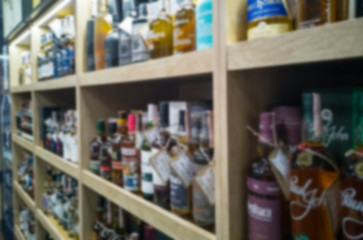Blurred abstract background of shelf in supermarket. Alcohol showcase blurred background.