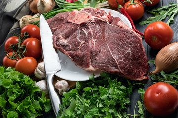 A juicy piece of fresh meat. Meat and vegetables. Cooking meat. A chef's knife. Balanced diet. Red meat.