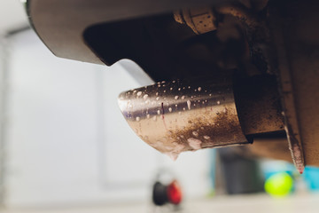 Car exhaust pipe with soap. Car wash background.
