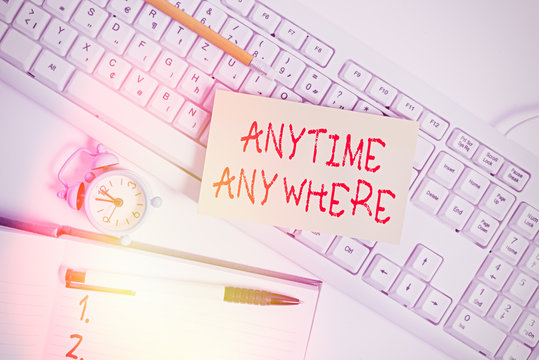 Text sign showing Anytime Anywhere. Business photo text saying that you can do something at every place and moment Flat lay above empty note paper on the pc keyboard pencils and clock - Powered by Adobe