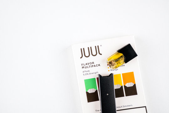 Oslo, Norway - 05.01.2020: Juul vape and juul flavoured pods isolated on white background. To illustrate an alternative to ordinary cigarettes and nicotine.