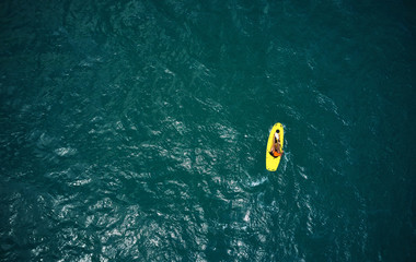 Aerial view of kayak boat in blue sea. Top view of canoe. Sport and leisure. Lifestyle