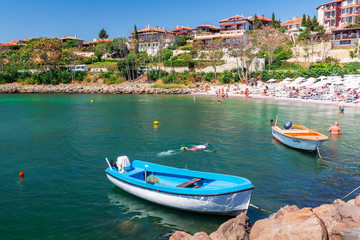 Fototapeta na wymiar nessebar, bulgaria - SEP 02, 2019: boats in harbor of an old town. popular travel destination. wonderful sunny weather. vintage fishermen houses and old architecture in the distance