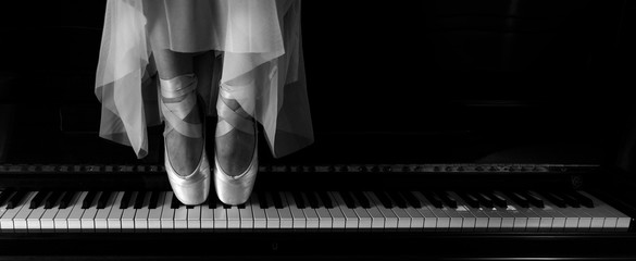 Ballerina standing on a piano