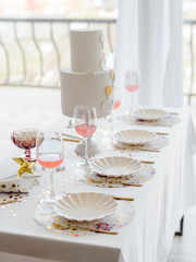 Birthday or wedding table setting in white colors with cocktails in glasses. Baby shower or girl party. Selective focus