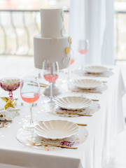 Birthday or wedding table setting in white colors with cocktails in glasses. Baby shower or girl party. Selective focus