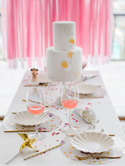 Birthday or wedding table setting in white colors with cocktails in glasses. Baby shower or girl party. Selective focus