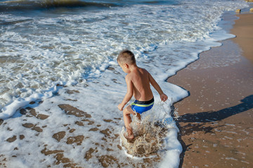 a child jumps in the waves