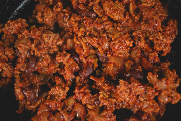 Closeup top view of spaghetti sauce with beans.